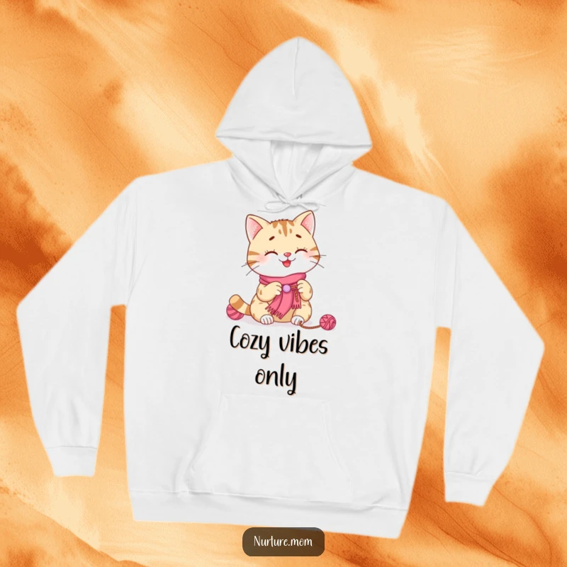 Funny cat knitting hoodie featuring a smiling cat happily knitting a tiny scarf, a cozy and humorous addition to any wardrobe.