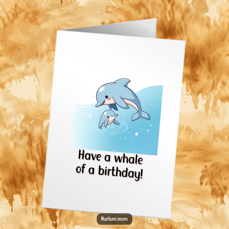 Free Printable Birthday Card: A playful dolphin mom guiding her calf through sparkling blue ocean water, celebrating joyfully.